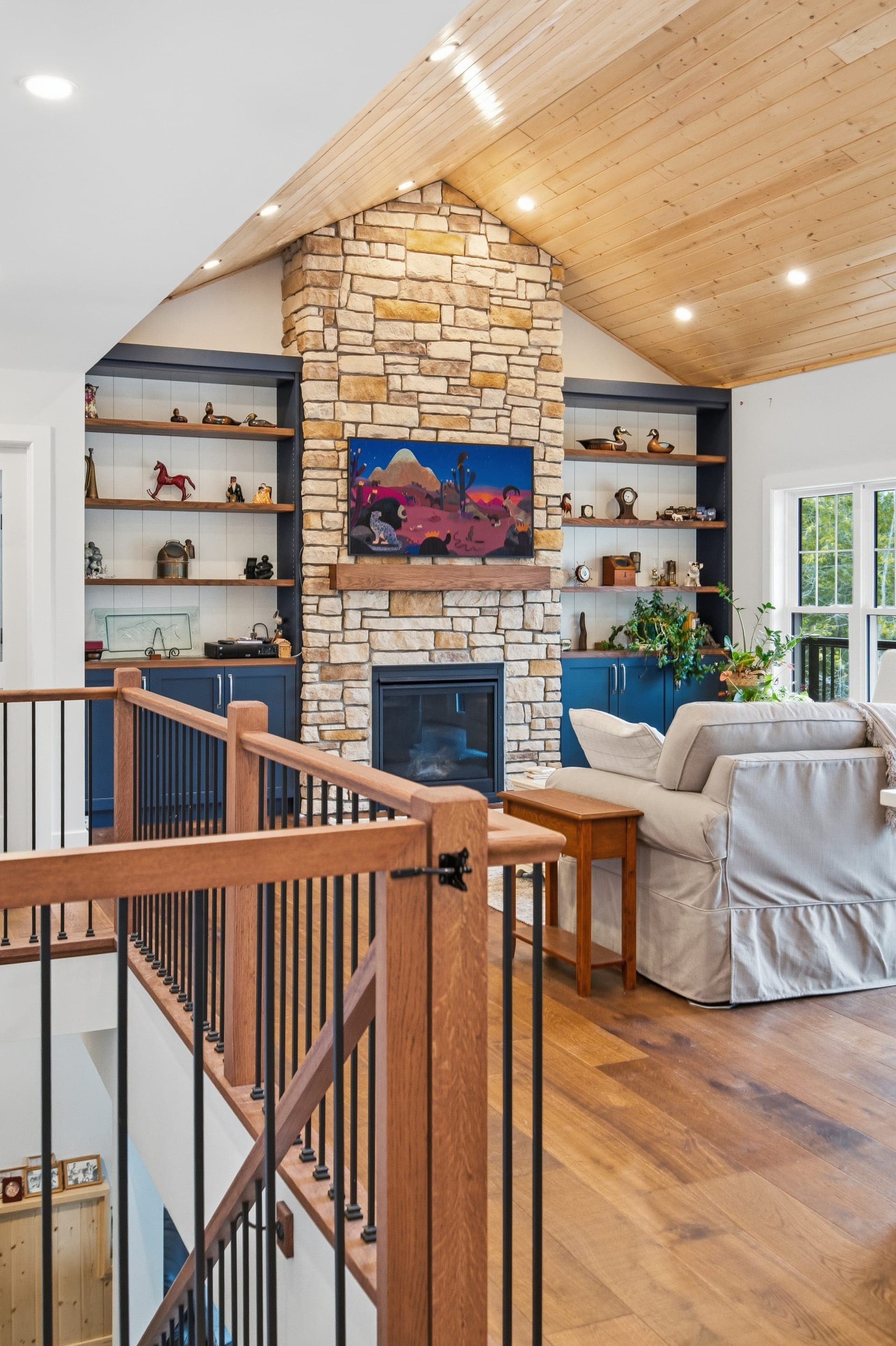Custom home interior with stone fireplace and vaulted ceiling