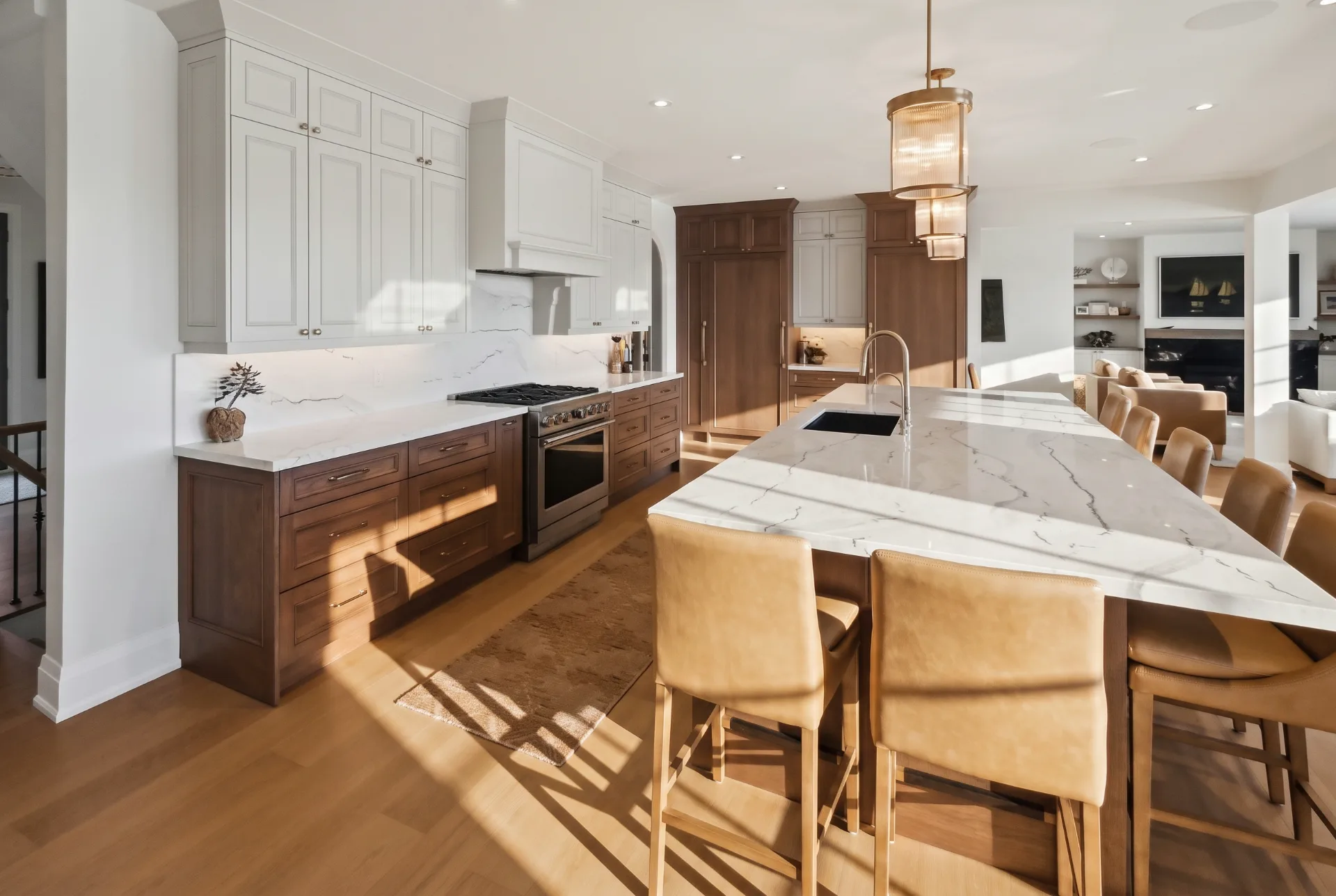 Kitchen with walnut cabinetry, marble island and leather counter stools